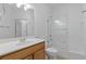 Bathroom with a tub, glass shower screen, a wood vanity and tile flooring at 3040 Peachtree Nw Rd # 1803, Atlanta, GA 30305