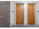 Hallway view of condo unit 1803 with wooden door and telephone sign at 3040 Peachtree Nw Rd # 1803, Atlanta, GA 30305