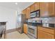 Kitchen view with stainless steel appliances, wooden cabinets, and granite countertops at 3040 Peachtree Nw Rd # 1803, Atlanta, GA 30305