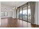 Sunlit living room featuring hardwood floors and sliding glass doors to a balcony with a city view at 3040 Peachtree Nw Rd # 1803, Atlanta, GA 30305