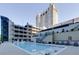 Luxury high-rise boasts a refreshing pool with lounge chairs and tables at 3040 Peachtree Nw Rd # 1803, Atlanta, GA 30305