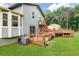 Multi-level deck overlooks the sprawling yard, complete with verdant lawn and mature trees at 320 Edna Dr, Stockbridge, GA 30281