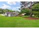 Expansive backyard features a lush lawn, mature trees, and a charming multi-level wooden deck at 320 Edna Dr, Stockbridge, GA 30281