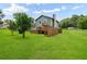 Spacious backyard with a deck, fence, and lush green lawn at 320 Edna Dr, Stockbridge, GA 30281