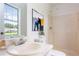 Bathroom featuring a shower, a window with a sink, and elegant wall art at 320 Edna Dr, Stockbridge, GA 30281