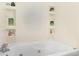 Relaxing bathtub with built-in shelves, perfect for storing bath essentials and decorations at 320 Edna Dr, Stockbridge, GA 30281