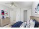 Bright bedroom features neutral walls, ceiling fan, and adjacent doors to walk-in closet and hallway at 320 Edna Dr, Stockbridge, GA 30281