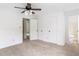 Clean bedroom with fresh carpet has a ceiling fan and neutral colors with easy access to a bathroom at 320 Edna Dr, Stockbridge, GA 30281