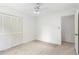 This carpeted bedroom features louvered closet doors and access to other rooms in the home at 320 Edna Dr, Stockbridge, GA 30281