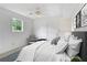 Bright bedroom featuring a ceiling fan, a comfortable chair, and elegant wall art at 320 Edna Dr, Stockbridge, GA 30281