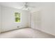 Bright bedroom has a window overlooking the backyard, with a closet for easy storage at 320 Edna Dr, Stockbridge, GA 30281