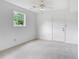 Clean, bright bedroom with neutral carpet and a ceiling fan at 320 Edna Dr, Stockbridge, GA 30281