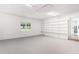 Spacious bonus room with carpet flooring, built-in shelving, and natural light from the window at 320 Edna Dr, Stockbridge, GA 30281