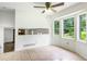 Bright breakfast nook with large windows and ceiling fan overlooks the yard at 320 Edna Dr, Stockbridge, GA 30281