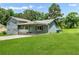 Home showcasing a covered carport with a well-maintained lawn on a sunny day at 320 Edna Dr, Stockbridge, GA 30281