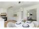 Bright eat-in kitchen featuring tiled floors, white cabinetry and a view of the living room at 320 Edna Dr, Stockbridge, GA 30281