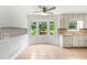 Well-lit kitchen featuring tile flooring, bay windows, and ample storage at 320 Edna Dr, Stockbridge, GA 30281