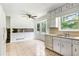 Bright and airy kitchen with white cabinets, and tile flooring at 320 Edna Dr, Stockbridge, GA 30281