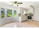 Bright kitchen with tile floors, white cabinets, and bay window at 320 Edna Dr, Stockbridge, GA 30281