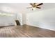 Bright living room features updated flooring, wainscoting, and ceiling fan at 320 Edna Dr, Stockbridge, GA 30281
