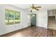 Bright living room with hardwood floors, stairs, and a large window at 320 Edna Dr, Stockbridge, GA 30281