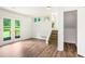 Open living room with wainscoting, access to backyard, and stairs to upper level at 320 Edna Dr, Stockbridge, GA 30281