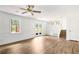 Spacious living room with ceiling fan, wainscoting, and convenient backyard access at 320 Edna Dr, Stockbridge, GA 30281