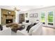 Cozy living room has a stone fireplace and access to the backyard through French doors at 320 Edna Dr, Stockbridge, GA 30281