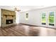 Cozy living room with stone fireplace, French doors, and modern flooring at 320 Edna Dr, Stockbridge, GA 30281