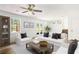 Comfortable living room features white furnishings, a ceiling fan and access to the backyard at 320 Edna Dr, Stockbridge, GA 30281