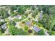 Aerial view of charming home, nestled on a lush lot with mature trees and a well-manicured lawn at 3467 Clubland Dr, Marietta, GA 30068