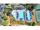 Aerial view of neighborhood pool and tennis courts with plenty of lounge chairs and umbrellas at 3467 Clubland Dr, Marietta, GA 30068