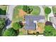 Aerial view of ranch-style home featuring a sprawling roof, lush landscaping and a private backyard at 3467 Clubland Dr, Marietta, GA 30068