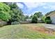The backyard features a large grassy area, a wood fence and mature trees at 3467 Clubland Dr, Marietta, GA 30068