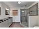 Bathroom featuring double sinks, framed mirrors, and a glass shower at 3467 Clubland Dr, Marietta, GA 30068