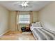 Bright bedroom with hardwood floors, a twin bed, and a window offering outdoor views at 3467 Clubland Dr, Marietta, GA 30068