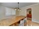 Well-lit dining area featuring hardwood floors, a rustic table and modern lighting at 3467 Clubland Dr, Marietta, GA 30068