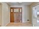 Grand wooden front door leading into the home's foyer and open floor plan at 3467 Clubland Dr, Marietta, GA 30068