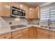 Updated kitchen featuring wood cabinets, tile backsplash, stainless steel microwave and gas cooktop at 3467 Clubland Dr, Marietta, GA 30068