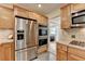 Kitchen with stainless refrigerator, double oven and light wood cabinets at 3467 Clubland Dr, Marietta, GA 30068