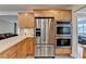 Kitchen boasts stainless refrigerator and double oven with light wood cabinets at 3467 Clubland Dr, Marietta, GA 30068