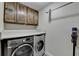 Modern laundry room with front load washer/dryer, cabinets and counter space for folding at 3467 Clubland Dr, Marietta, GA 30068