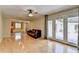 Open living area with light hardwood floors, providing views of both the kitchen and the backyard through glass doors at 3467 Clubland Dr, Marietta, GA 30068