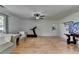 Bright living room boasts hardwood floors and neutral walls, accentuated by natural light and a ceiling fan at 3467 Clubland Dr, Marietta, GA 30068