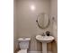 Neutral powder room featuring a pedestal sink, round mirror, and a standard toilet at 3467 Clubland Dr, Marietta, GA 30068
