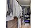 Spacious walk-in closet with custom shelving, hanging rods, and wooden floors for organized storage solutions at 3467 Clubland Dr, Marietta, GA 30068