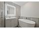Modern bathroom with a soaking tub, light grey vanity, and lighted mirror at 57 Forsyth Nw St # 14B, Atlanta, GA 30303