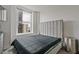 Modern bedroom with a padded headboard and a large window with city views at 57 Forsyth Nw St # 14B, Atlanta, GA 30303