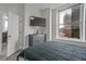 Bedroom with modern decor, a large window, and views of the city skyline at 57 Forsyth Nw St # 14B, Atlanta, GA 30303
