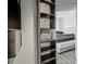 Storage solutions abound in this organized closet with shelves and drawers, connecting to a modern bedroom at 57 Forsyth Nw St # 14B, Atlanta, GA 30303